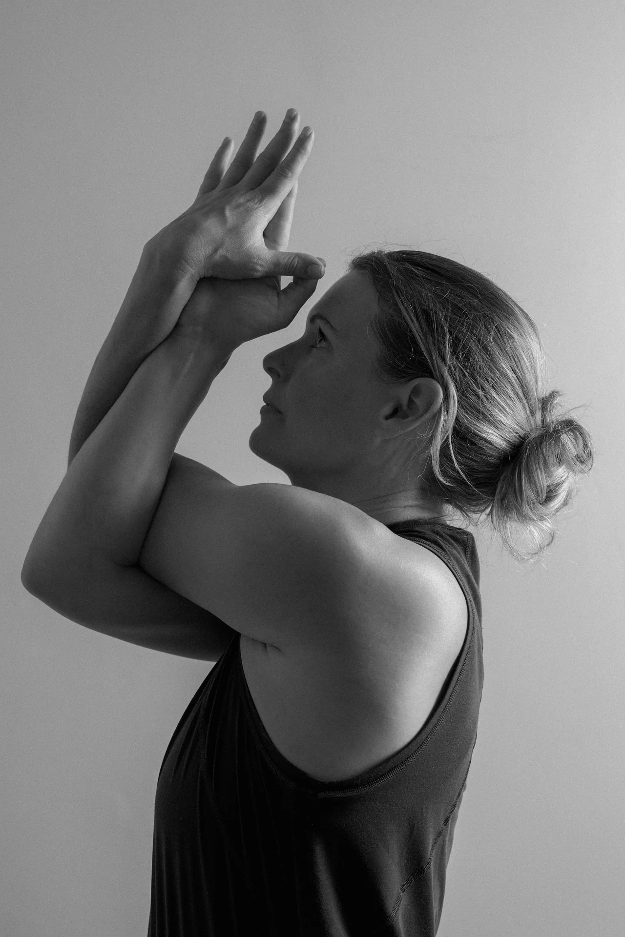 Black and white photograph of a dancer seated on a studio floor